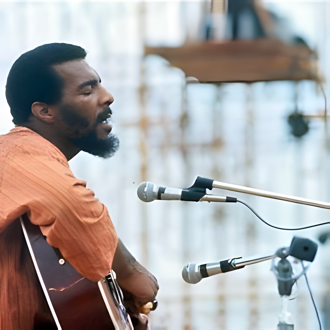 Richie Havens strumming his guitar, intense focus